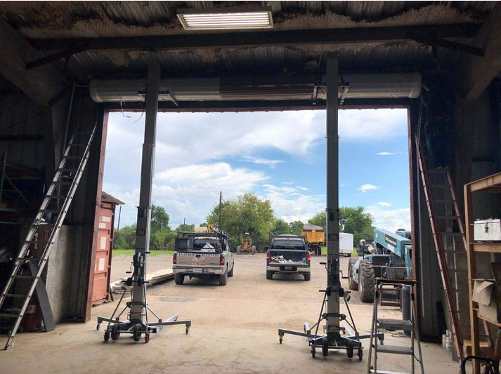 Local garage door repair team in Baltimore, OH working on a residential garage door, demonstrating professional service in the local area.