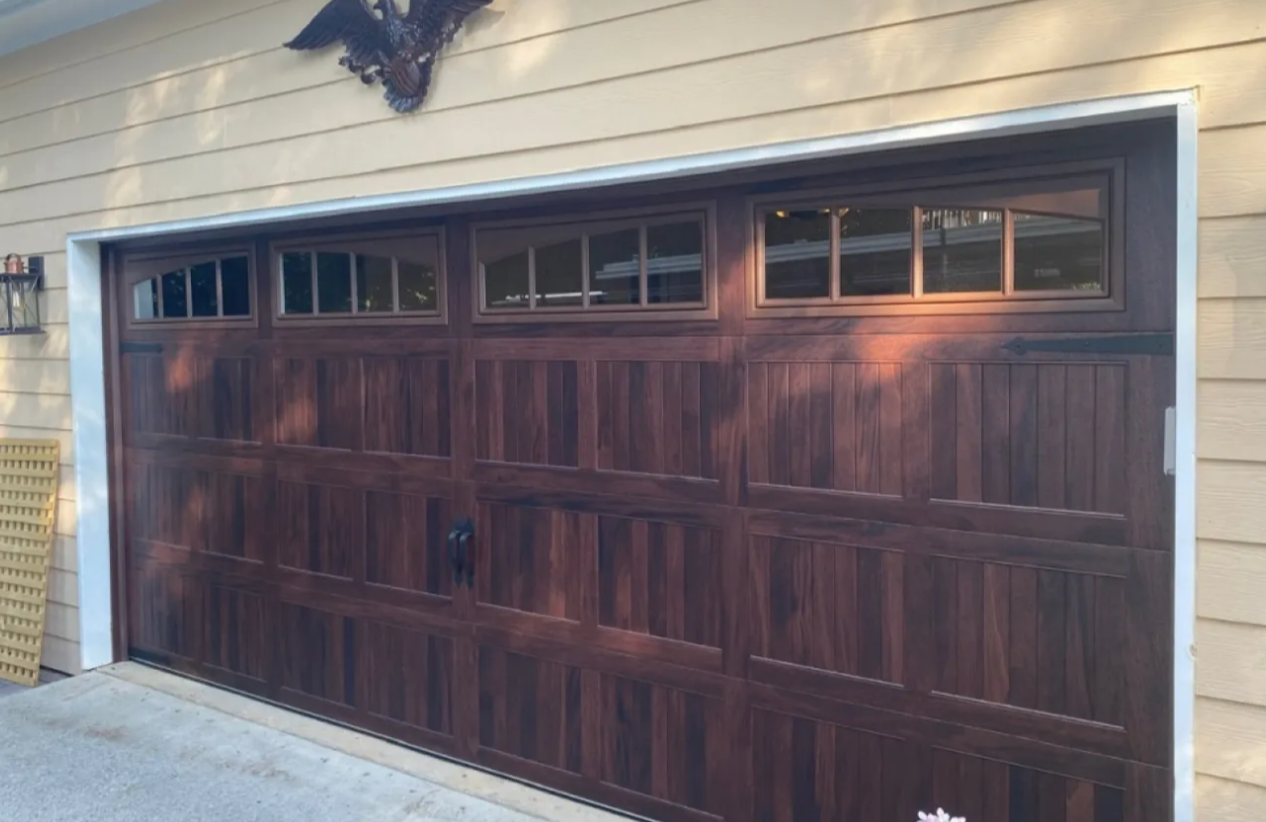 Custom garage door with intricate woodwork and modern features installed in a Baltimore, OH residence, showcasing high-quality custom garage door options available locally