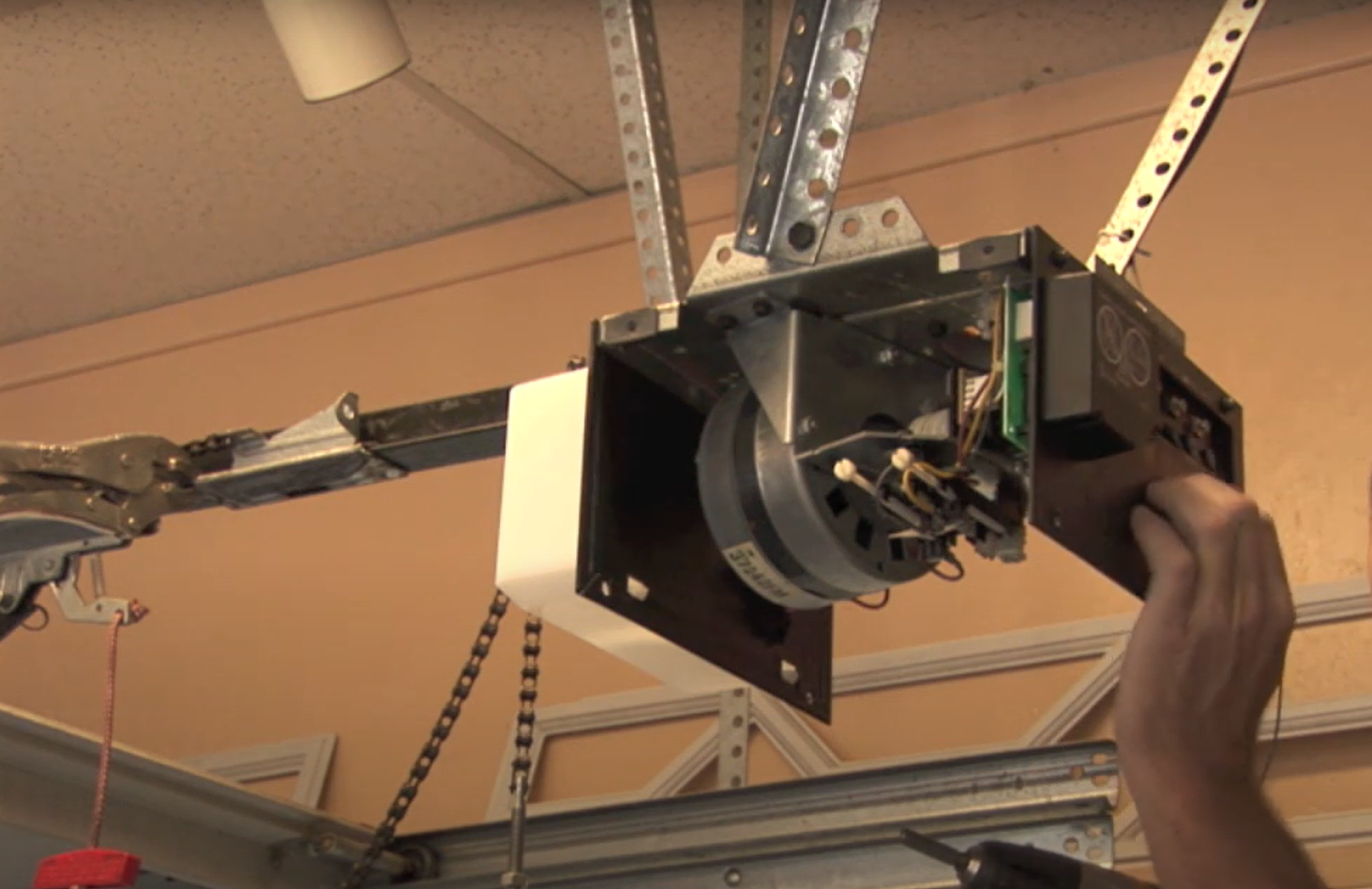 Professional technician repairing a garage door opener in Baltimore, OH for Garage Door Repair Baltimore OH.