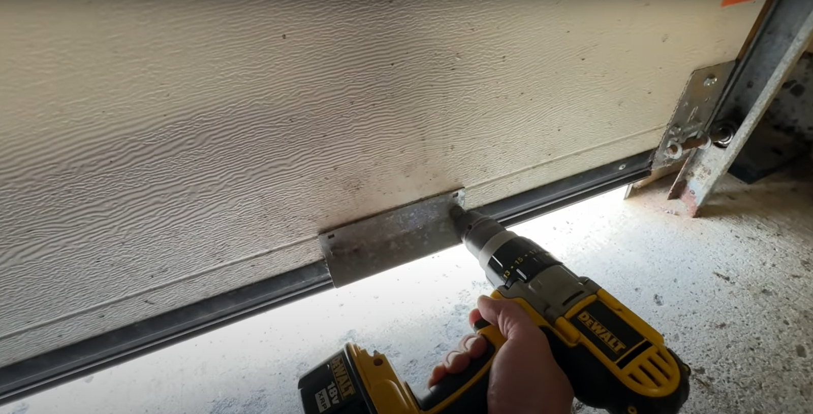 Technician performing garage door panel repair on a residential garage in Baltimore, OH