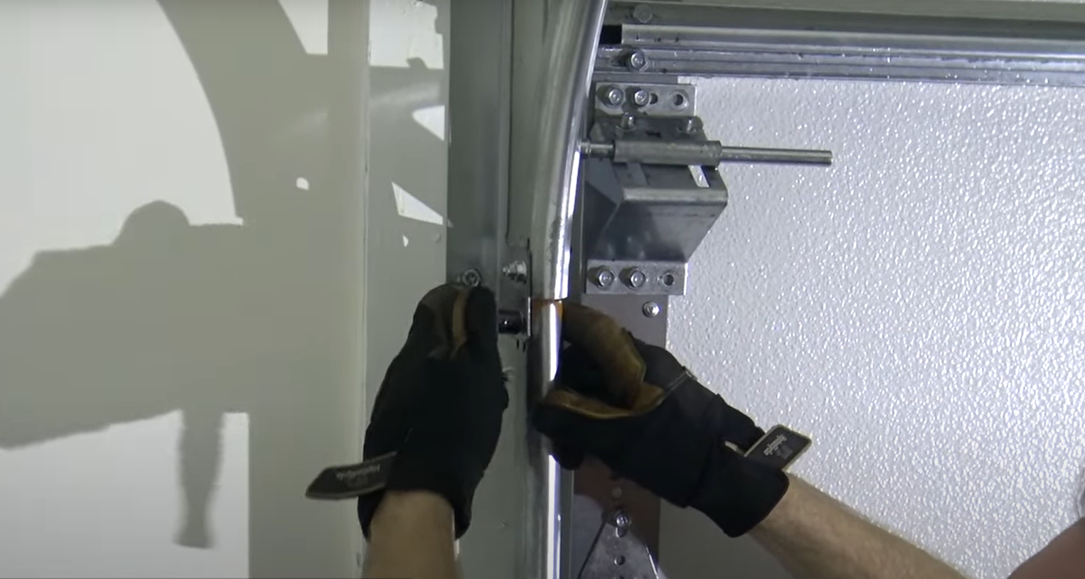 Professional technician performing garage door track repair in Baltimore, OH.