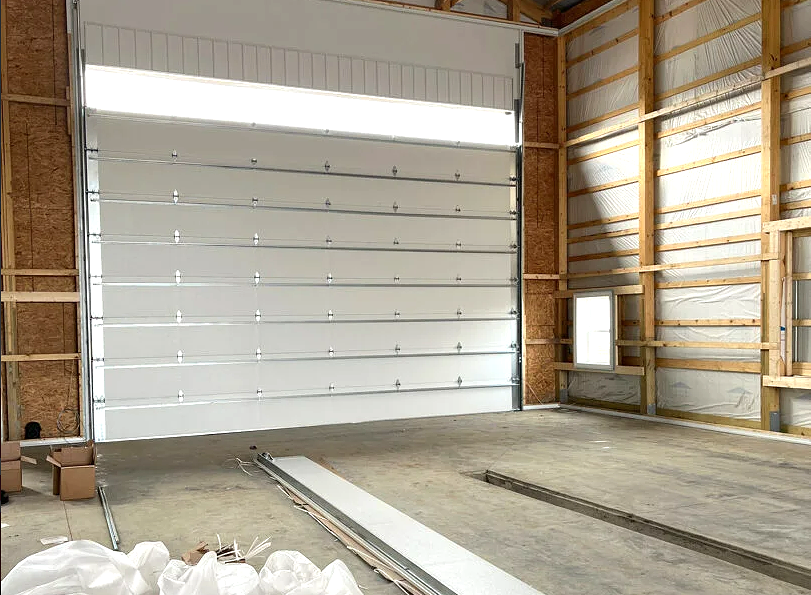 Modern garage door installation in a residential home with the Baltimore skyline in the background; featuring a sleek design and high-quality hardware in a well-lit setting.