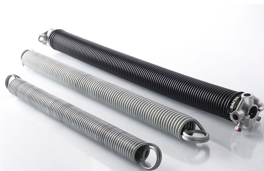 Professional technician performing garage door spring repair in Baltimore OH, showcasing expertise and precision with specialized tools."